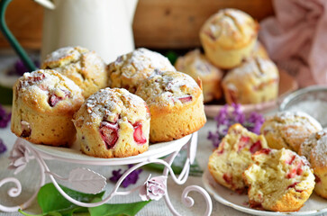 Rhubarb muffins on a rustic plateau on a wooden background