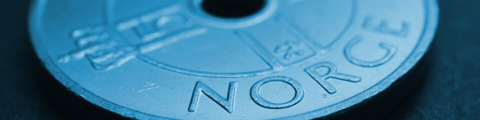 Translation: Norway. 1 Norwegian krone coin close up. National currency of Norway. Blue tinted...
