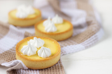 Fototapeta na wymiar Lemon tartlets. Mini tarts with lemon curd. Baking background, pastry background