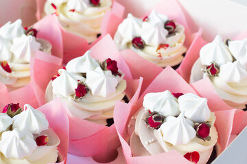 Cup cakes with  roses, pink paper cups.