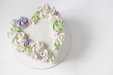 Heart cake with cream decor. Romantic holiday cake, love cake, wedding cake