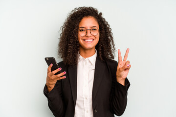 Young business Brazilian woman holding mobile phone isolated on white background showing number two with fingers.