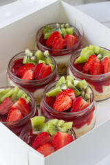 Summer fruits cheesecake decorated with strawberries and kiwies