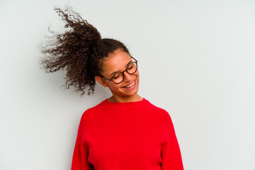 Young Brazilian woman isolated on blue background dancing and having fun.