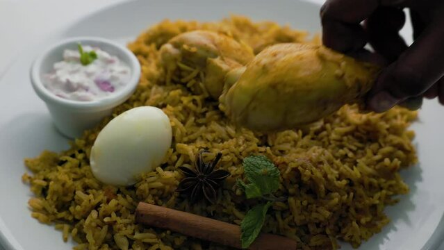 Chicken biryani Spicy Indian Malabar biryani Hyderabadi biryani pulao with egg. 4K slow motion video footage of Kerala India Sri Lanka style biriyani made of basmati rice