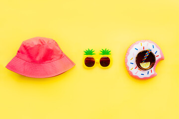 Flat lay of summer vibes concept with colorful pool party items, funny pineapple shape sunglasses,...