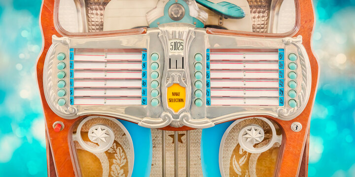 Vintage colorful jukebox in front of blue background with bokeh