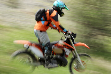Blurry image of motorcycle riders during motocross race