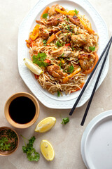 Asian style, stir fry noodles with chicken meat and vegetable, dark background. homemade food