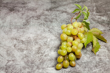 bunch of green grapes on a dark background