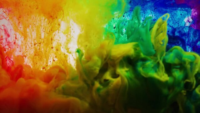 Deep multi-colored paint jets flow in clear water on white background. Bright colors create decorative abstract background slow motion macro, rainbow colors, lgbt
