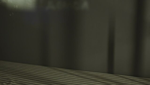 Dark jail cell at night . Gray concrete wall of prison room . Empty jailhouse room with bed and chair . Traces on wall . Prison life or quest concept . Shot on ARRI Alexa Cinema camera in slow motion