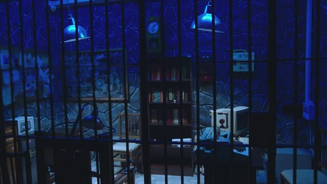 Dark jail cell at night . Hanging Swaying swinging lamps on dark room . Silhouette of policeman opening Interrogation room before interrogating . Prison life concept . Shot on camera ARRI slow motion