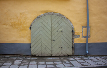 Old wooden door of vintage historic building in the Old town of Tallinn, Estonia