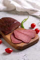Beef jerky pieces. Sliced pieces of dry meat on a stone floor. close up