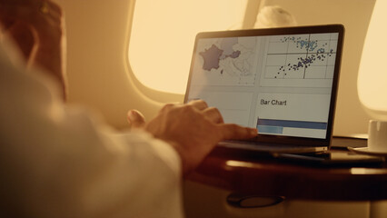 Manager hands working graphs on laptop computer closeup. Man using touchpad