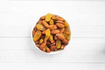 Raw nuts almonds and dried grapes raisins, concept healthy snack.