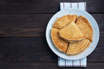 Pancakes with chocolate banana filling. Wooden rustic table, sweet delicious dessert.