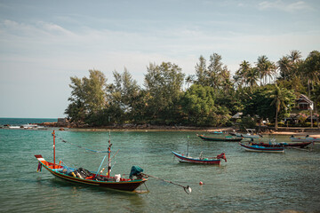 Fototapeta na wymiar Koh Phangan, Thailand - December 23rd, 2019 : long-tail boat docked in the north of Koh Phangan with on sunny day in the Gulf of Thailand