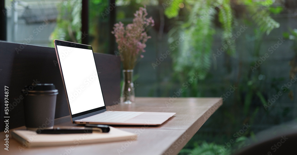 Poster mockup laptop computer with empty display on wood table.