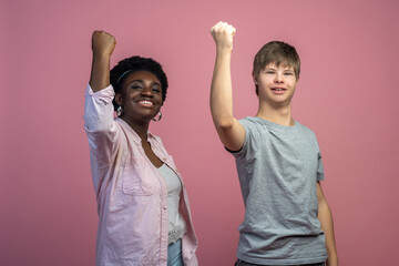 Woman and guy with raised fist looking at camera