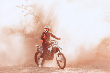 Live shot of male sportsman training on motorbike at hot summer day, outdoors. Motocross rider in action. Motocross sport