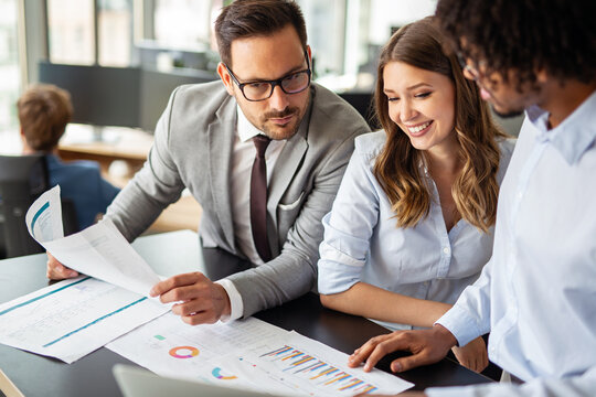 Group of successful business people meeting in office, sharing their ideas.