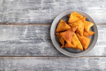 nachos on gray plate on a gray wooden background. Top view, copy space.