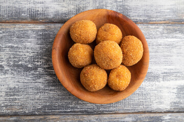 meat balls on a wooden plate on a gray. Top view.