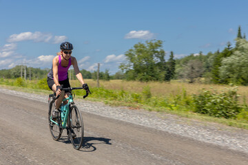 Fototapeta na wymiar woman cycling on gravel road
