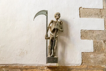 Ploumilliau, France. Statue of the Ankou, a 16th century personification of death at the Church of...