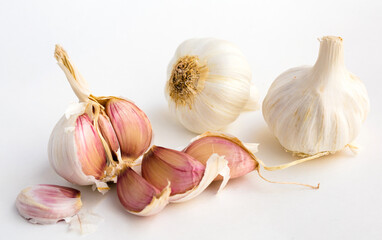 garlic heads and cloves on white background