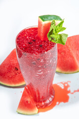 Refreshing cold summer drink watermelon slushie, iced Granita dessert beverage, crushed watermelon ice on trendy high-colored white pink background copy space