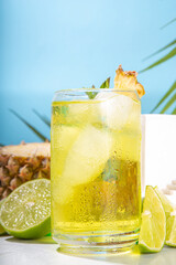 Cold summer tropical drink with crushed ice, lime and mint. Sweet pineapple lemonade copy space