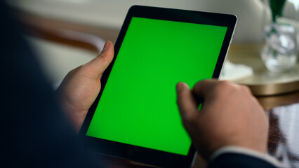Worker hands holding green screen tablet closeup. Successful man using mockup