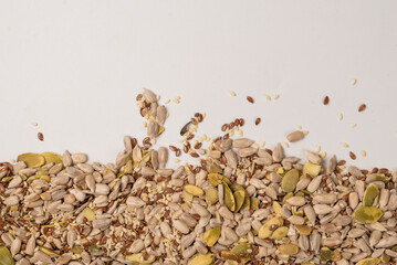 Mix of seeds for a salad. A pile of mixed seeds isolated on white background.