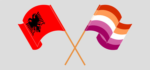 Crossed and waving flags of Albania and Lesbian Pride