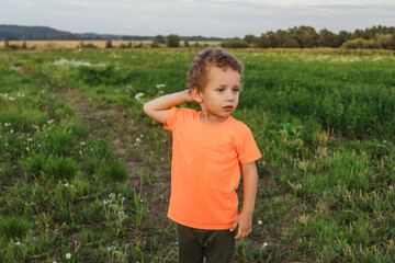 Little boy in a meadow, sunset light.