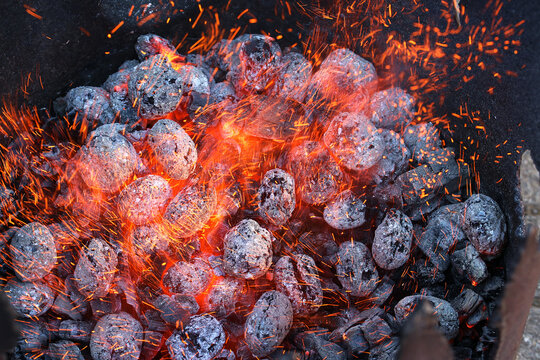Glimmering heat from glowing charcoal to harden knives
