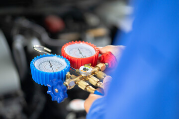 Check car air conditioning system refrigerant recharge.