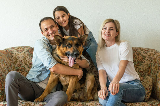 German Shepherd And Family. German Shepherd Is The Best Friend Of The Child.