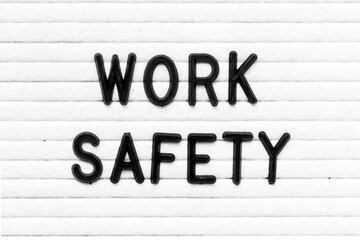 Black color letter in word work safety on white felt board background