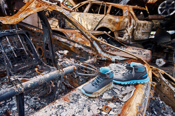 Children boots on top of destroyed car in Bucha