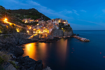 Manarola at night. Illuminated Italian town in 5 Terre. Famous Tourist destination in Italy