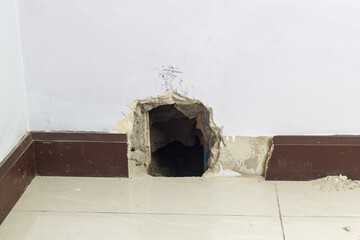 Concrete walls in the shade that have been smashed or destroyed to find holes for water leaks. Home repair concept.	