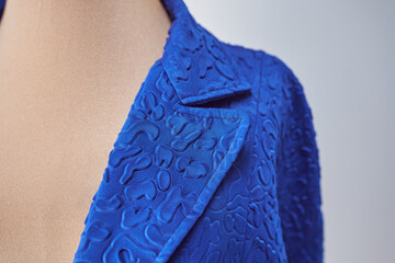 lapel and break line of blue jacket in fabric with design