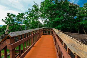 Fototapeta na wymiar Background of wooden walkways (wooden bridges) created for high-angle views on mountains, natural attractions, or parks that have forest preservation