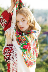 Portrait of a sweet blonde in traditional national clothes.