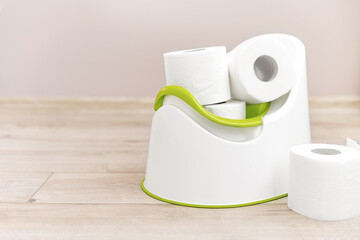 Baby potty with toilet paper inside.