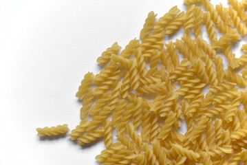 Twisted raw pasta on a white background close-up